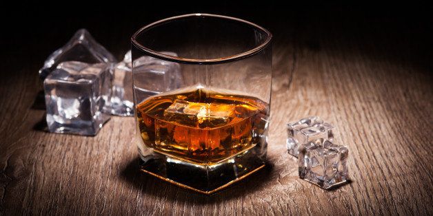 whiskey in glass on wooden table