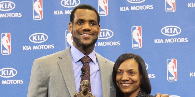 AKRON, OH - MAY 2: LeBron James of the Cleveland Cavaliers is joined by his mother Gloria James as he receives the Maurice Podoloff Trophy as the 2009-10 NBA Most Valuable Player presented by Kia Motors on May 2, 2010 at James A Rhodes Arena on the University of Akron campus in Akron, Ohio. NOTE TO USER: User expressly acknowledges and agrees that, by downloading and or using this photograph, User is consenting to the terms and conditions of the Getty Images License Agreement. Mandatory Copyright Notice: Copyright 2010 NBAE (Photo by Nathaniel S. Butler/NBAE via Getty Images)