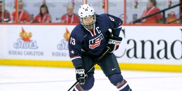 OTTAWA, CANADA - APRIL 8: Julie Chu #13 of Team USA shoots the puck during the IIHF Womens World Championship Semi-Final game against Team Finland at Scotiabank Place on April 8, 2013 in Ottawa, Ontario, Canada. (Photo by Richard Wolowicz/Freestyle Photography/Getty Images)