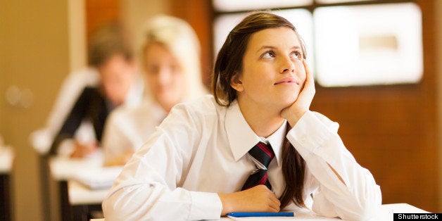 high school girl daydreaming in classroom