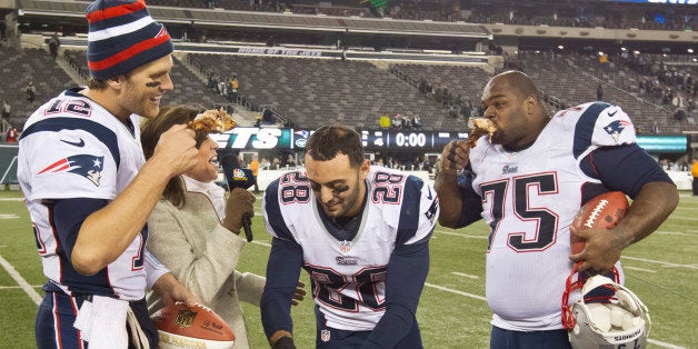 EAST RUTHERFORD, NJ - NOVEMBER 22: New England Patriots players, left to right, Tom Brady, Steve Gregory and Vince Wilfork join television broadcaster Michele Tafoya eating turkey legs after defeating the New York Jets 49-19 during a Thanksgiving Day game at Metlife Stadium on Thursday, Nov. 22, 2012. (Photo by Matthew J. Lee/The Boston Globe via Getty Images)