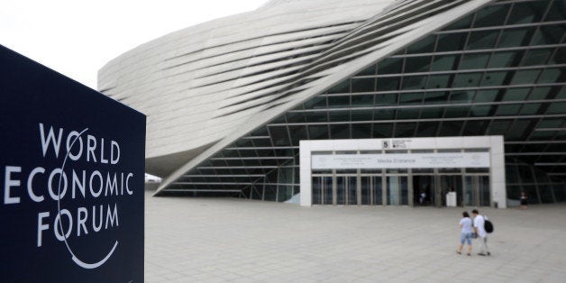 The World Economic Forum logo is displayed on a sign outside the Dalian International Conference Center in Dalian, China, on