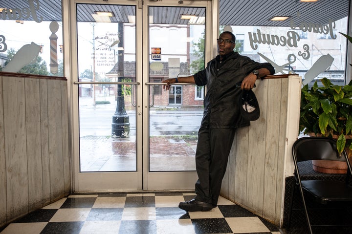 Jeano Farrow stands at the front door of Jeano's Beauty & Barber in downtown Kinston, North Carolina. The shop stayed open on Saturday as the Neuse River rose about a mile to the south.