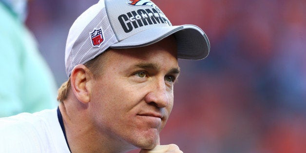 DENVER, CO - JANUARY 19: Peyton Manning #18 of the Denver Broncos celebrates after they defeated the New England Patriots 26 to 16 during the AFC Championship game at Sports Authority Field at Mile High on January 19, 2014 in Denver, Colorado. (Photo by Elsa/Getty Images)