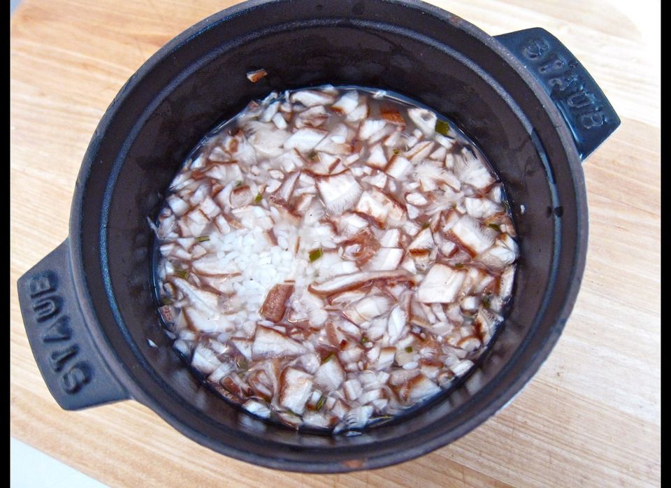 Rice and shiitakes ready to cook in a tiny, heavy pot
