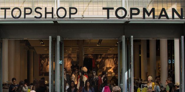Pedestrians walk past a Topshop Topman store operated by Arcadia Group PLC, in the shopping district of Soho in New York, U.S., on Saturday, Sept. 14, 2013. Consumers views of the U.S. economic outlook deteriorated in September to the weakest level in a year. Photographer: Craig Warga/Bloomberg via Getty Images