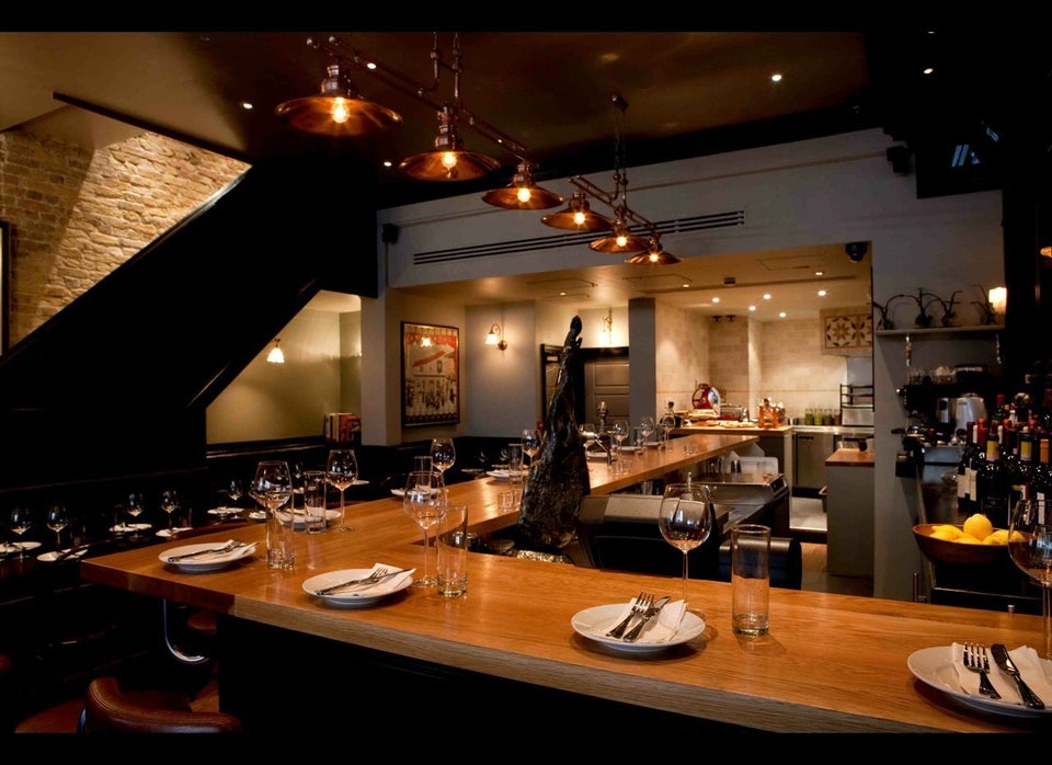 Opera Tavern's downstairs bar-dining room with a kitchen view