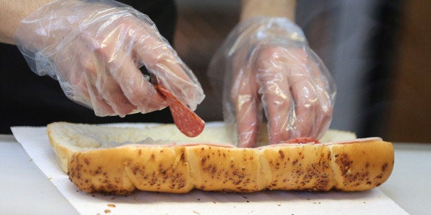 An employee prepares a customer's sandwich order at the food counter of a Subway fast food restaurant in Moscow, Russia, on Sunday, April 7, 2013. McDonald's, which virtually created the market for burgers and fries in the country and convinced Russians it's OK to eat with their hands, must fend off a growing challenge from rivals Burger King Worldwide Inc., Subway Restaurants, Yum! Brands Inc. and Wendy's Co. Photographer: Andrey Rudakov/Bloomberg via Getty Images