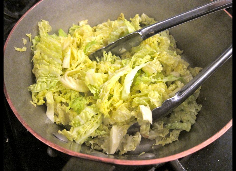 Strips of savoy cabbage in the risotto pan with butter