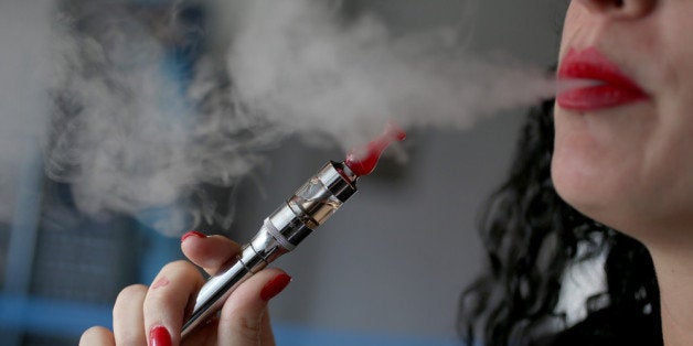 MIAMI, FL - FEBRUARY 20: Julia Boyle enjoys an electronic cigarette at the Vapor Shark store on February 20, 2014 in Miami, Florida. As the popularity of E- cigarettes continue to grow, leading U.S. tobacco companies such as Altria Group Inc. the maker of Marlboro cigarettes are annoucing plans to launch their own e-cigarettes as they start to pose a small but growing competitive threat to traditional smokes. (Photo by Joe Raedle/Getty Images)