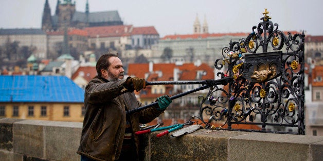 PRAGUE, CZECH REPUBLIC - MARCH 18: Roman Kotrc from Charles Bridge Artists Association removed love padlocks from Charles Bridge, on March 18, 2014 in Prague, Czech Republic. Charles Bridge Artsist Association believe that placing the love padlocks on the historic sight is an act of vandalism and remove approximately 40kg of padlocks each fortnight. The act of fixing a padlock to a historic sight is a growing phenomenon in cities across Europe as couples leave them as a symbol of their love. (Photo by Matej Divizna/Getty Images)