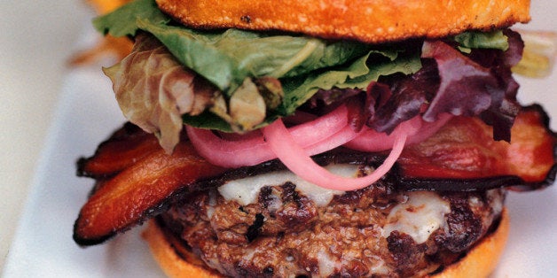 UNITED STATES - APRIL 05: The burger at Chef Marc Meyer's Cookshop is made of organic, grass-fed beef and topped with greenmarket greens, Vermont cheddar and strips of Berkshire bacon. (Photo by Malu Alvarez/Bloomberg via Getty Images)