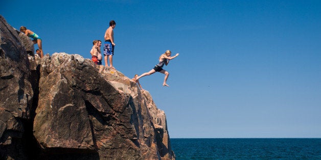 [UNVERIFIED CONTENT] A girl jumps into Lake Superior from the rocky shore of Little Presque Isle in the Upper Peninsula of Michigan.