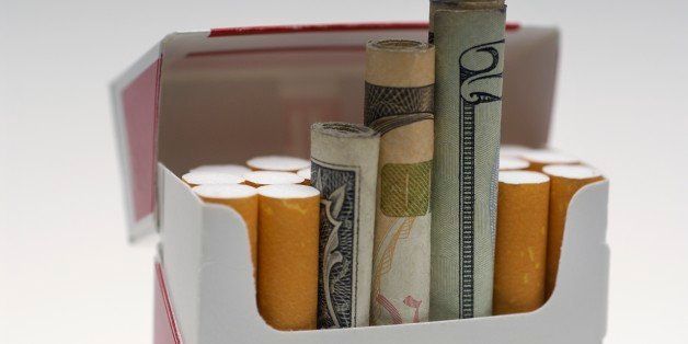 Money rolled up in cigarette box close-up