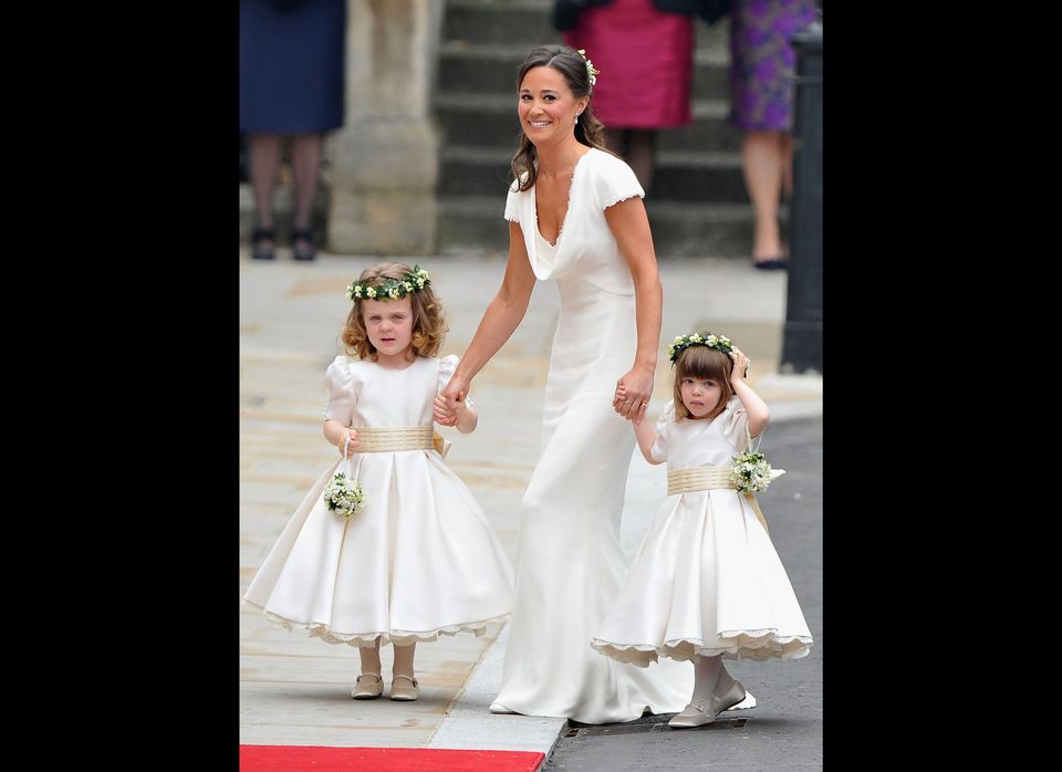 Sister of the bride and Maid of Honour Pippa Middleton holds hands with Grace Van Cutsem and Eliza Lopes