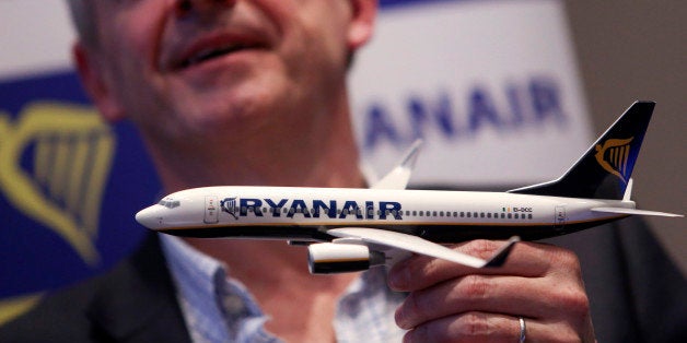 Michael O'Leary, chief executive officer of Ryanair Holdings Plc, holds a model aircraft as he speaks during a news conference in London, U.K., on Thursday, Nov. 21, 2013. The Irish carrier announced today that it would be adding more destinations from Manchester Airports Group's London Stansted airport in 2014. Photographer: Chris Ratcliffe/Bloomberg via Getty Images