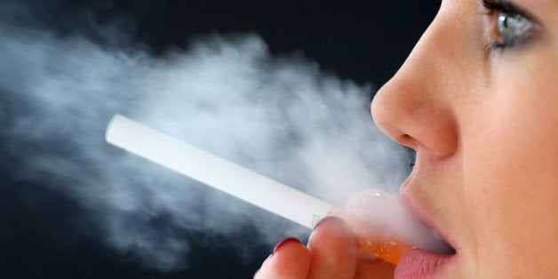 LONDON, ENGLAND - APRIL 02: In this photo illustration a woman smokes an e-cigarette on April 2, 2014 in London, England. Wales is considering a ban on the smoking of electronic cigarettes in enclosed public places. (Photo by Peter Macdiarmid/Getty Images)