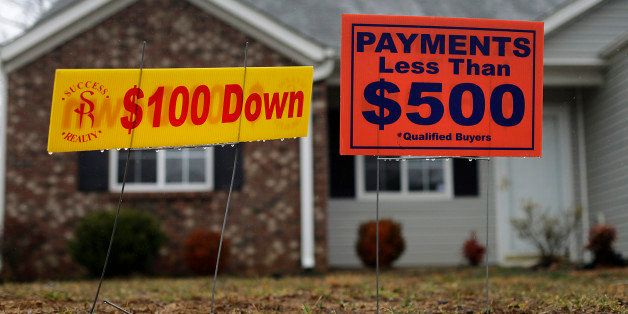 Signs are displayed outside of a foreclosed home in Greensboro, North Carolina, U.S., on Thursday, Feb. 16, 2012. The National Association of Realtors is scheduled to release existing homes data on Feb. 22. Photographer: Victor J. Blue/Bloomberg via Getty Images