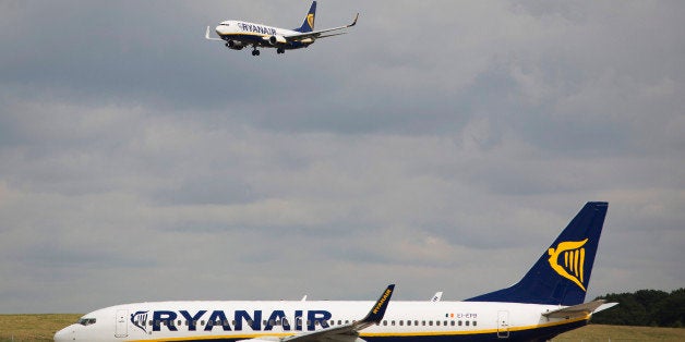 A passenger aircraft operated by Ryanair Holdings Plc comes into land as one aircraft waits to depart from Stansted Airport, operated by Manchester Airports Group (MAG) in Stansted, U.K., on Tuesday, Sept. 10, 2013. From two planes in 1995, EasyJet has grown to more than 200 Airbus SAS aircraft carrying more than 59 million people annually, 20 million fewer than Ryanair. Photographer: Simon Dawson/Bloomberg via Getty Images