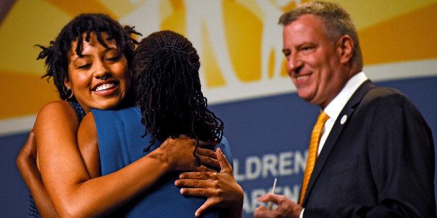 NATIONAL HARBOR, MD - MAY 06: New York City Mayor Bill de Blasio looks on as his wife, Chirlane McCray (C) hugs their daughter, Chiara de Blasio (L), before she received a special recognition award at the National Council for Behavioral Health's Annual Conference at the Gaylord National Resort & Convention Center on May 6, 2014 in National Harbor, Maryland. The general session on Children's Mental Health Awareness Day helped bring awareness to mental health issues in young adults and children. (Photo by Patrick Smith/Getty Images)
