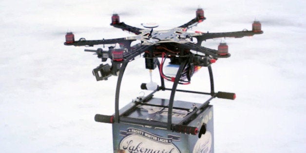 In this Jan. 16, 2014 image from video provided by Lakemaid Beer, a mini-drone lands with a 12-pack of beer for ice fishing anglers on Minnesotaᅢ까タᅡルs Lake Mille Lacs. Lakemaid president Jack Supple said he thought Amazon's package delivery plan would better be applied on a wide open frozen lake where ice anglers are manning their fishing holes in tiny shanties, but the Federal Aviation Administration heard him talking about his plans on the radio and grounded future deliveries. (AP Photo/Courtesy Lakemaid Beer)
