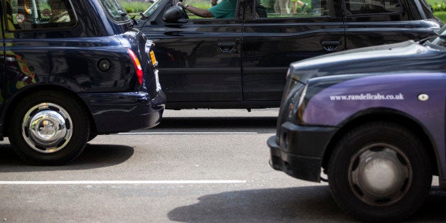 LONDON, ENGLAND - JUNE 02: Taxis drive on the streets of Westminster on June 2, 2014 in London, England. The controversial mobile application 'Uber', which allows users to hail private-hire cars from any location, is opposed by established taxi drivers and currently serves more than 100 cities in 37 countries. London's black cabs are seeking a High Court ruling on the claim that the Uber software is breaking the law by using an app as a taxi meter to determine rates. (Photo by Oli Scarff/Getty Images)