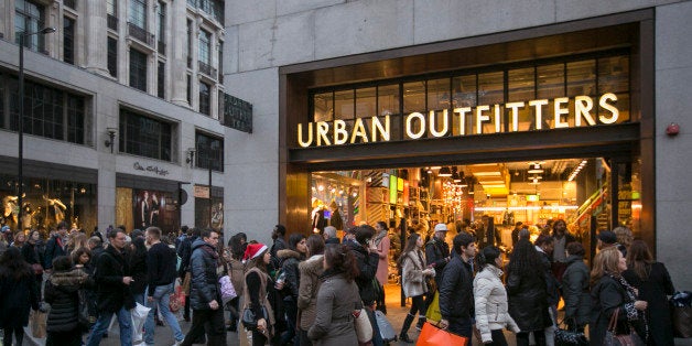 LONDON, ENGLAND - DECEMBER 14: Christmas shoppers walk outside Urban Outfitters on December 14, 2013 in London, England. As Christmas Day approaches, London's central shopping districts attempt to lure shoppers into stores with last minute deals in an effort to pull sales away from online outlets. (Photo by Dan Dennison/Getty Images)