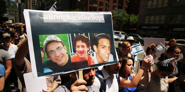 NEW YORK, NY - JUNE 16: People gather for a vigil for the three missing Israeli teens outside of the Israeli Consulate on June 16, 2014 in New York City. According to the Israeli defense Forces (IDF), Gilad Shaar (16) Naftali Frenkel, (16) and Eyal Yifrach (19) have been missing since late Thursday or Friday and were last seen around Gush Etzion. Israeli soldiers have detained over 150 Palestinian suspects in the search for the three teens. (Photo by Spencer Platt/Getty Images)