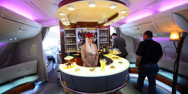A stewardess poses inside the bar of an Emirates Airlines A380 aircraft presented at the International Aerospace Exhibition (ILA) on June 8, 2010 at the Schoenefeld airport in Berlin. Dubai airline Emirates said it had placed an order worth 11.5 billion dollars with Airbus for 32 more A380 'superjumbo' passenger aircraft. The biannual show is the third biggest in Europe after those in Britain and France, was expected to draw more than 1,100 exhibitions from 37 countries. AFP PHOTO / JOHANNES EISELE (Photo credit should read JOHANNES EISELE/AFP/Getty Images)