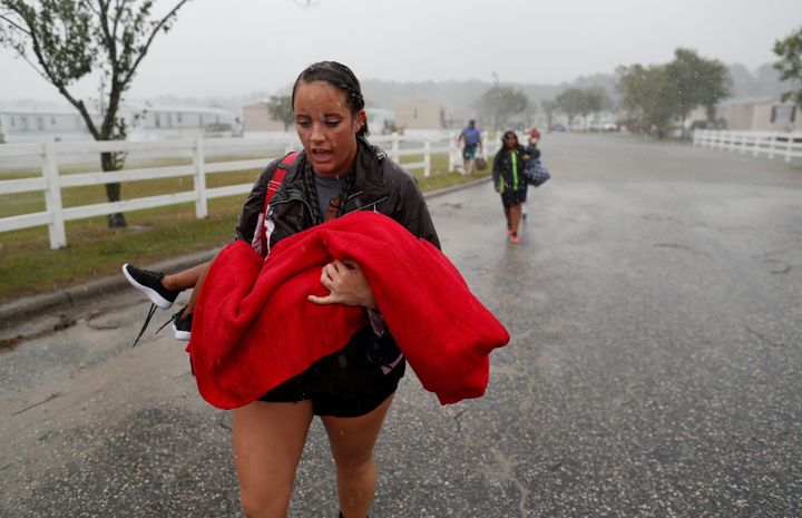 Maggie Belgie of The Cajun Navy carries a child as a flooding trailer community is evacuated during Hurricane Florence in Lumberton, North Carolina, U.S. September 15, 2018. 