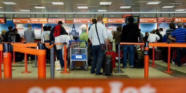 Passengers queue up at the Easyjet counter at Berlin's Schoenefeld airport on May 25, 2011, as air traffic is disturbed as ashes spewed from Iceland's Grimsvoetn volcano. Ash pouring from the Icelandic volcano reached northern Germany, forcing the closure of airports from Hamburg to Berlin, amid fears European air traffic could soon suffer further disruptions. The cloud is the second in barely a year from an Icelandic volcano to disrupt European air traffic. The airports will reopen by afternoon, German Transport Minister Peter Ramsauer said. AFP PHOTO / JOHANNES EISELE (Photo credit should read JOHANNES EISELE/AFP/Getty Images)