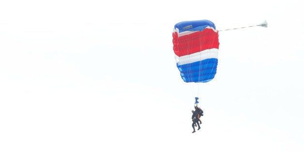 KENNEBUNKPORT, ME - JUNE 12: Former U.S. President George H.W. Bush and Mike Elliott, US Army Sergeant 1st Class (ret), jump out of a helicopter and parachutes down to St. Anne's Episcopal Church on June 12, 2014 in Kennebunkport, Maine. The President is celebrating his 90th birthday today. (Photo by Eric Shea/Getty Images)