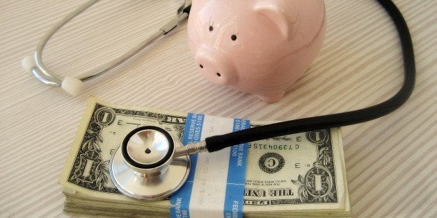 A picture of a piggy bank, a stethoscope and a wad of bank notes.