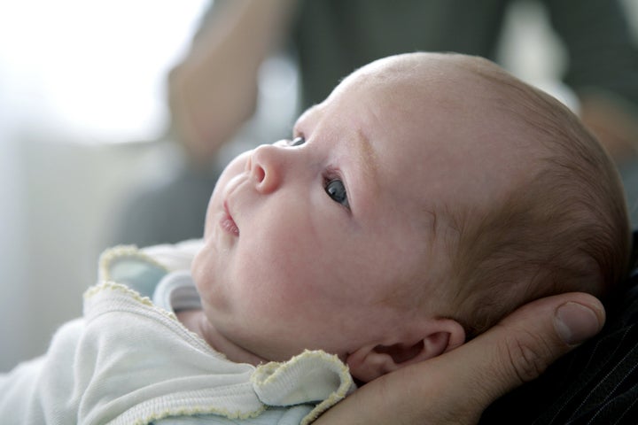 newborn baby with confused...