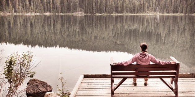 woman sitting in solitude by...