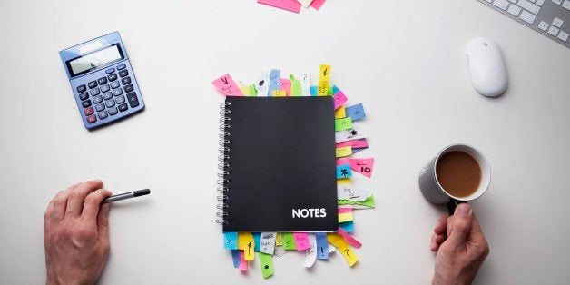 Studio shot of hands note pad full of post it notes