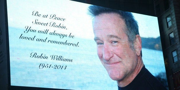 NEW YORK, NY - AUGUST 13: Times Square pays tribute to Robin Williams as Broadway dims the lights to honor his life and career on August 13, 2014 in New York City. (Photo by Walter McBride/Getty Images)