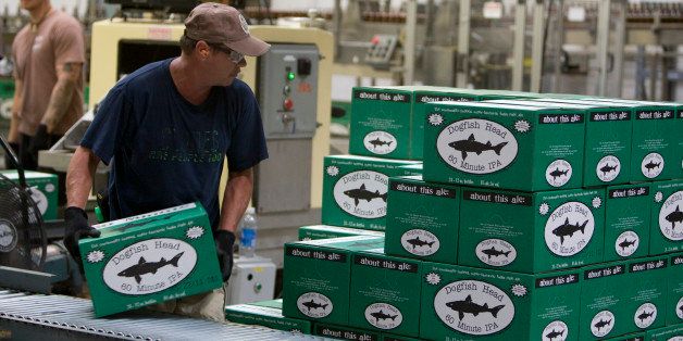 Employees work on the bottling line at the Dogfish Head Craft Brewery Inc. facility in Milton, Delaware, U.S., on Wednesday, June 22, 2011. Craft brewing in the U.S. grew 11 percent by volume and 12 percent by retail dollars, as overall U.S. beer sales shrank, according to the Brewers Association Nationwide, the number of craft brewers increased to 1,716, from 1,552 in 2009. Photographer: Scott Eells/Bloomberg via Getty Images