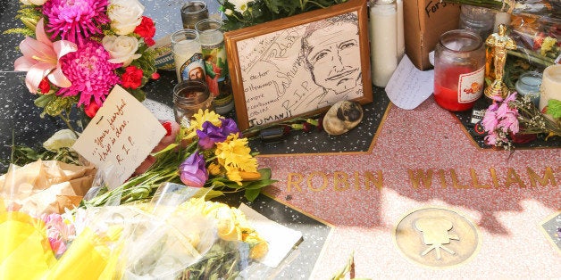 HOLLYWOOD, CA - AUGUST 12: Flowers are placed on the Hollywood Walk of Fame Star and the hand and footprint in memory of actor Robin Williams on August 12, 2014 in Hollywood, California. (Photo by Paul Archuleta/FilmMagic)