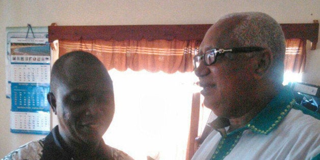 In this photo taken on Sunday, July 13, 2014, Dr. Sheik Humarr Khan, left, talks with former Sierra Leone's Minister of Finance John Oponjo Benjamin at an Ebola center in Kenema, Sierra Leone. Dr. Sheik Humarr Khan a leading doctor died from ebola, officials said, as a major regional airline announced it was suspending flights to the cities hardest hit by an outbreak that has killed more than 600 people. Dr. Sheik Humarr Khan, who was praised as a national hero for treating the disease in Sierra Leone, was confirmed dead by health ministry officials there. He had been hospitalized in quarantine. (AP Photo)