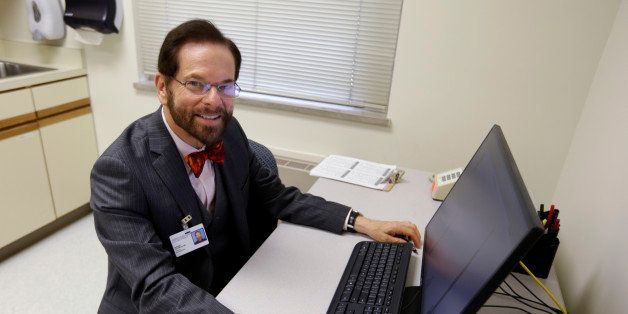 Dr. Robert Palinkas, director of the McKinley Health Center at the University of Illinois, poses in an exam room in Urbana, Ill., Thursday, Aug. 21, 2014. Extra health checks are part of protocols campuses throughout the United States have in place as they prepare for as many as 10,000 students from Nigeria, Guinea, Liberia and Sierra Leone, where more than 1,000 people have died in the worst Ebola outbreak in history. (AP Photo/Michael Conroy)
