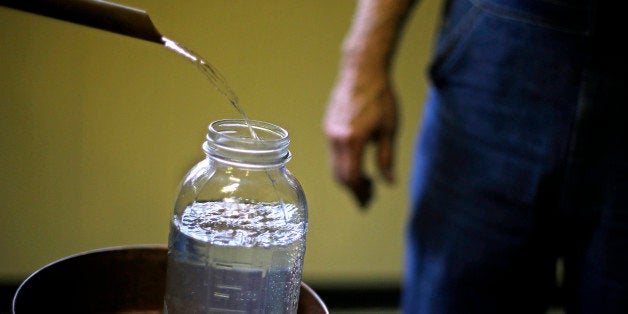 In this Friday, Nov. 16, 2012 photo, a batch of genuine corn whisky empties out of a condenser barrel before being tempered in the Dawsonville Moonshine Distillery, in Dawsonville, Ga. Distillers are making their first batches of legal liquor in this tiny Georgia town's hall, not far from the mountains and the maroon, orange and gold canopy of trees that once hid bootleggers from the law. (AP Photo/David Goldman)