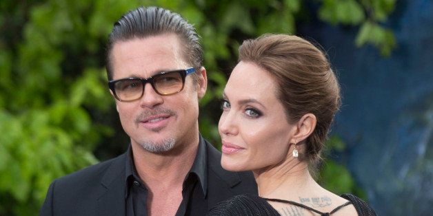 LONDON, UNITED KINGDOM - MAY 08: Brad Pitt and Angelina Jolie attend a private reception as costumes and props from Disney's 'Maleficent' are exhibited in support of Great Ormond Street Hospital at Kensington Palace on May 8, 2014 in London, England. (Photo by Julian Parker/UK Press via Getty Images)