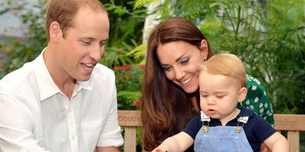 This photo taken Wednesday, July 2, 2014, and released Monday, July 21, 2014, to mark Prince George's first birthday, shows Britain's Prince William and Kate Duchess of Cambridge and the Prince during a visit to the Sensational Butterflies exhibition at the Natural History Museum, London. (AP Photo/John Stillwell, Pool)