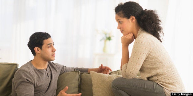 USA, New Jersey, Jersey City, Couple talking on sofa