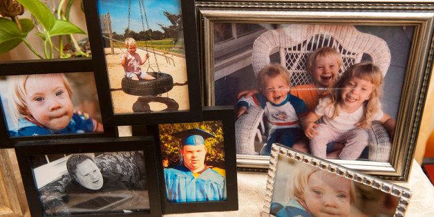 MT. AIRY, MD - JULY 16: Photographs of Ethan Saylor as he was growing up adorn a side table in the dining room of Patti Saylor's home Tuesday July 16, 2013 in Mt. Airy, MD. Ethan Saylor, a twenty-six year old with Down syndrome, died of asphyxia after he refused to leave a movie theater and the three off-duty deputies restrained him. (Photo by Katherine Frey/The Washington Post via Getty Images)