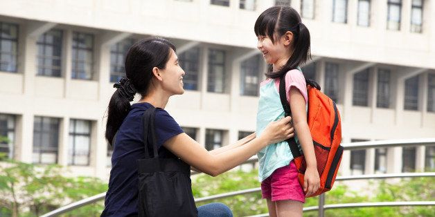 back to school.happy asian mother with daughter in school