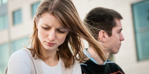 Portrait of young woman and man outdoor on street having relationship problems