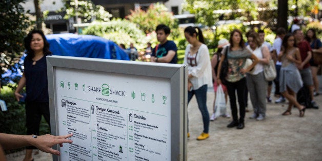 NEW YORK, NY - AUGUST 18: People wait in line at Shake Shack on August 18, 2014 in Madison Square Park in New York City. Shake Shack is allegedly considering going public and holding an initial price offering (IPO). (Photo by Andrew Burton/Getty Images)