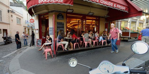 People sits outside the 'Cafￃﾃￂﾩ des Deux Moulins' on August 7, 2013 in Paris where scenes of the movie 'Le fabuleux destin d'Amelie Poulain' (Amelie) was shot in 2000. AFP PHOTO / ERIC FEFERBERG (Photo credit should read ERIC FEFERBERG/AFP/Getty Images)